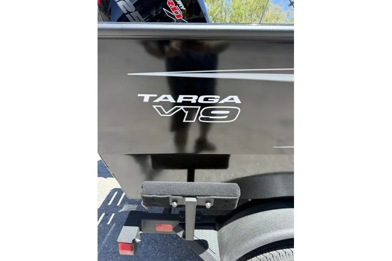 Slide: The Image of 2026 Tracker Targa V-19 Combo boat side view with logo and trailer. - 4