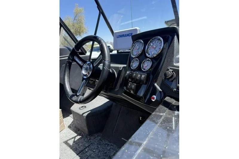 Slide: The Image of 2026 Tracker Targa V-19 Combo boat dashboard with steering wheel and instrument panel. - 8