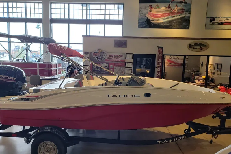 The Image of 2026 Tahoe T16 boat with red and white design displayed indoors. - 0