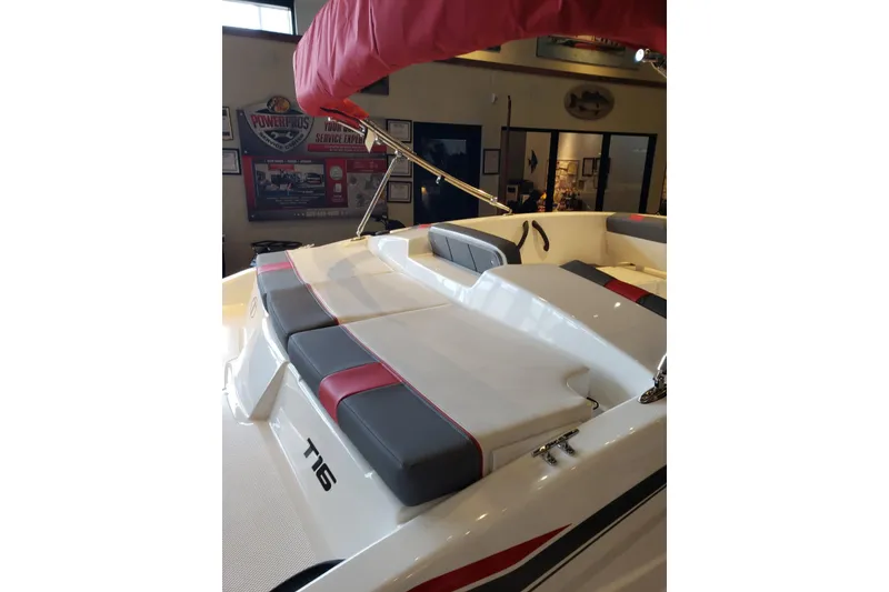 Slide: The Image of 2026 Tahoe T16 boat interior with cushioned seating and red canopy. - 10