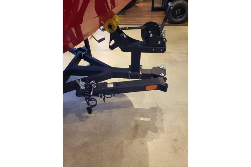 Slide: The Image of Trailer hitch of a 2026 Tahoe T16 boat on display indoors. - 5