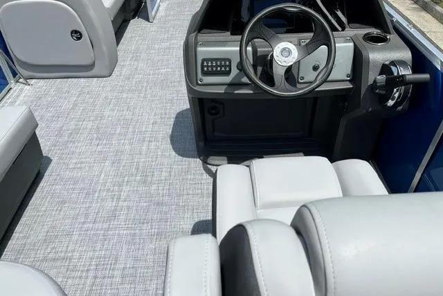 Slide: The Image of Interior view of 2026 Sun Tracker Party Barge 18 DLX with modern steering console. - 10