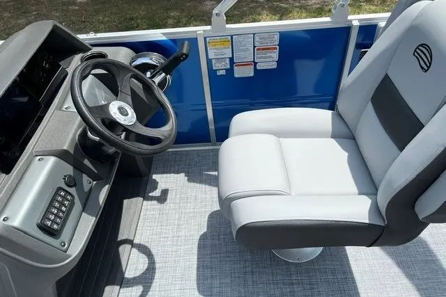 Slide: The Image of 2026 Sun Tracker Party Barge 18 DLX helm with steering wheel and captain's chair. - 8
