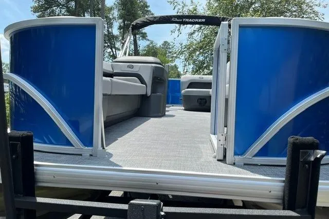Slide: The Image of 2026 Sun Tracker Party Barge 18 DLX pontoon boat with blue panels and spacious deck. - 3