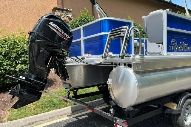 Slide: The Image of 2026 Sun Tracker Party Barge 18 DLX with Mercury outboard motor on trailer. - 5