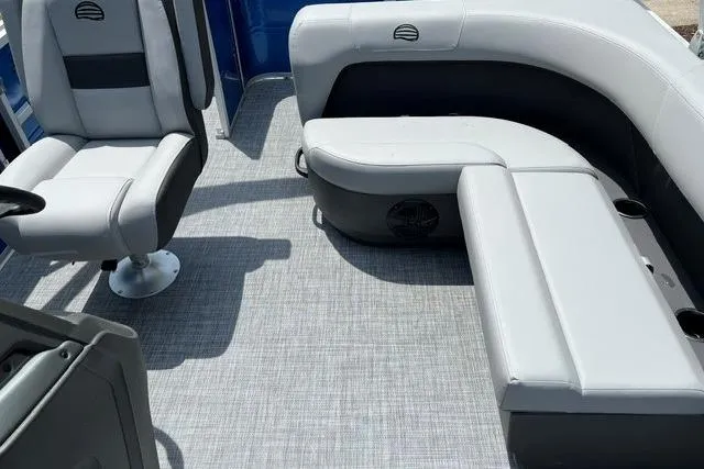 Slide: The Image of 2026 Sun Tracker Party Barge 18 DLX interior with gray seating and flooring. - 7