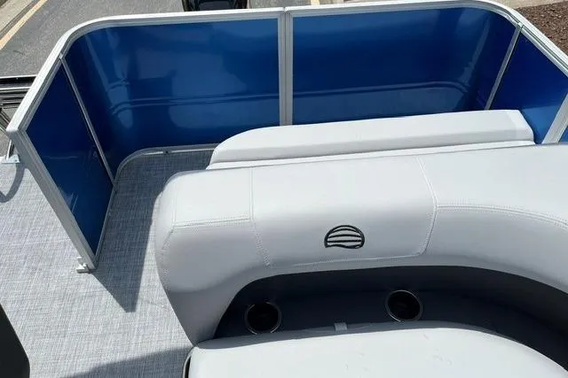 Slide: The Image of 2026 Sun Tracker Party Barge 18 DLX interior with blue panels and gray seating. - 9