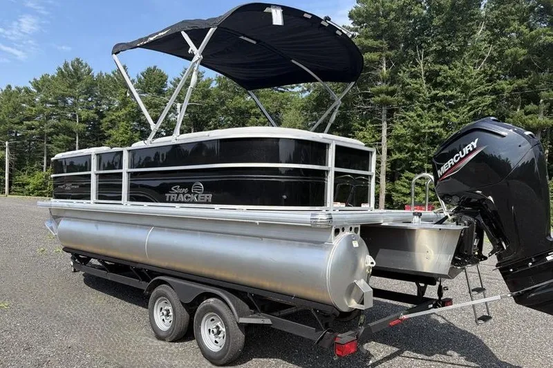 Slide: The Image of 2026 Sun Tracker Party Barge 20 DLX pontoon boat with Mercury engine on trailer. - 4