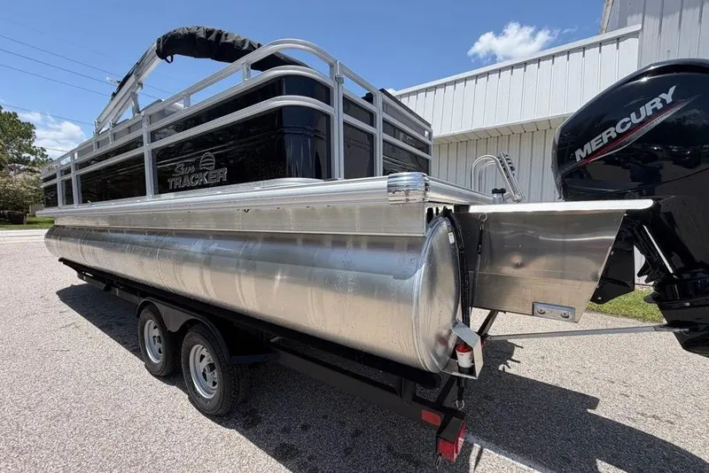 Slide: The Image of 2026 Sun Tracker Sportfish 24 XP3 pontoon boat with Mercury engine on trailer. - 95