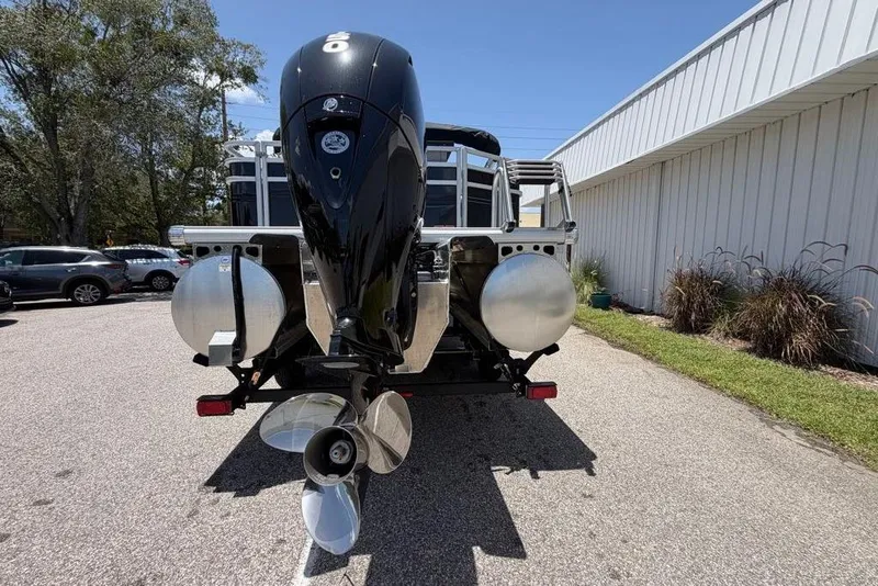 Slide: The Image of Rear view of 2026 Sun Tracker Sportfish 24 XP3 boat with powerful outboard motor. - 97