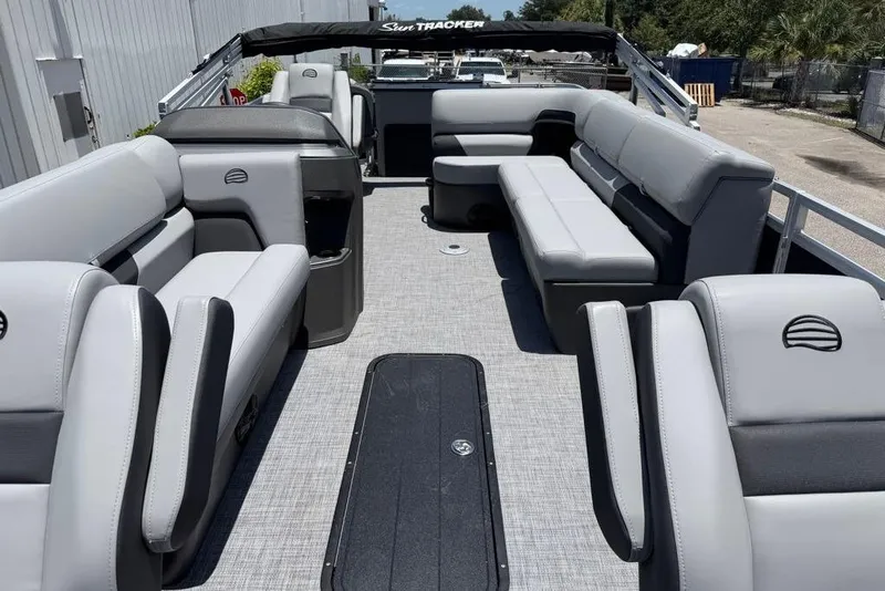 Slide: The Image of 2026 Sun Tracker Sportfish 24 XP3 pontoon boat interior with gray seating and spacious layout. - 5