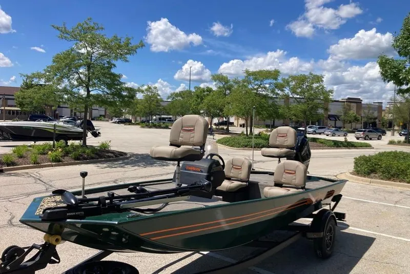 Slide: The Image of 2026 Tracker Bass Tracker Classic Limited boat in parking lot under blue sky. - 4