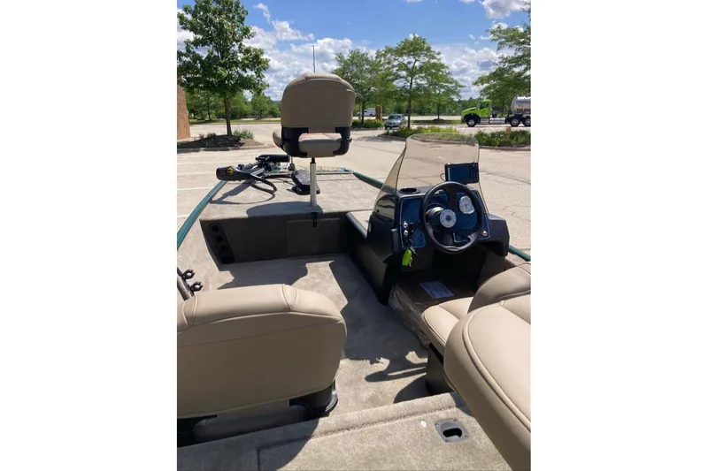 Slide: The Image of 2026 Tracker Bass Tracker Classic Limited boat interior with steering wheel and seating. - 2