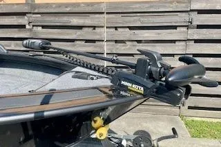 Slide: The Image of 2026 Tracker Targa V-19 Combo boat with Minn Kota trolling motor, parked outdoors. - 6
