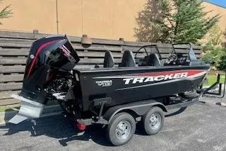 Slide: The Image of 2026 Tracker Targa V-19 Combo boat on trailer, parked outdoors. - 2