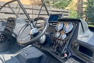 Slide: The Image of 2026 Tracker Targa V-19 Combo boat dashboard with steering wheel and gauges. - 4