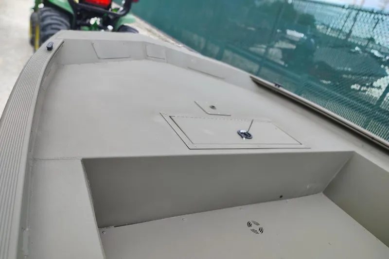 Slide: The Image of 2026 Tracker Grizzly 1754 Utility boat deck, featuring storage compartment and durable design. - 2