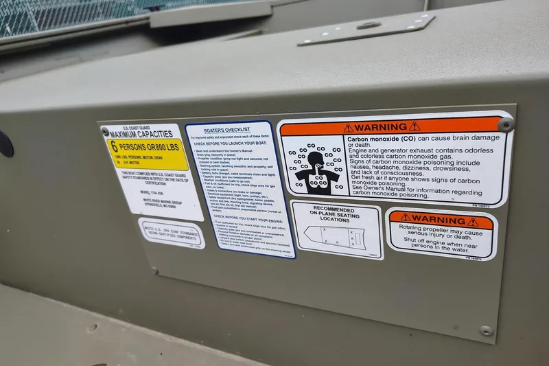 Slide: The Image of Warning labels on 2026 Tracker Grizzly 1754 Utility boat, including capacity and safety instructions. - 4