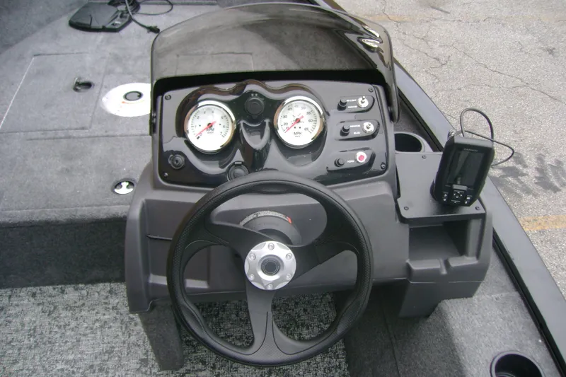 Slide: The Image of 2026 Tracker Super Guide V-16 SC boat dashboard with steering wheel and gauges. - 12