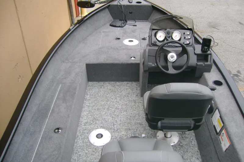 Slide: The Image of 2026 Tracker Super Guide V-16 SC boat interior with steering console and seating. - 8