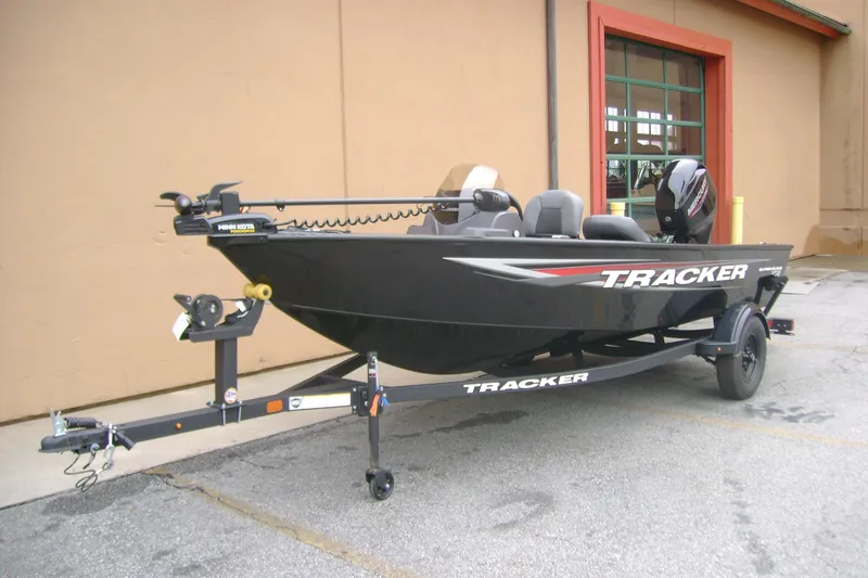 Slide: The Image of 2026 Tracker Super Guide V-16 SC fishing boat on trailer, parked outdoors. - 3