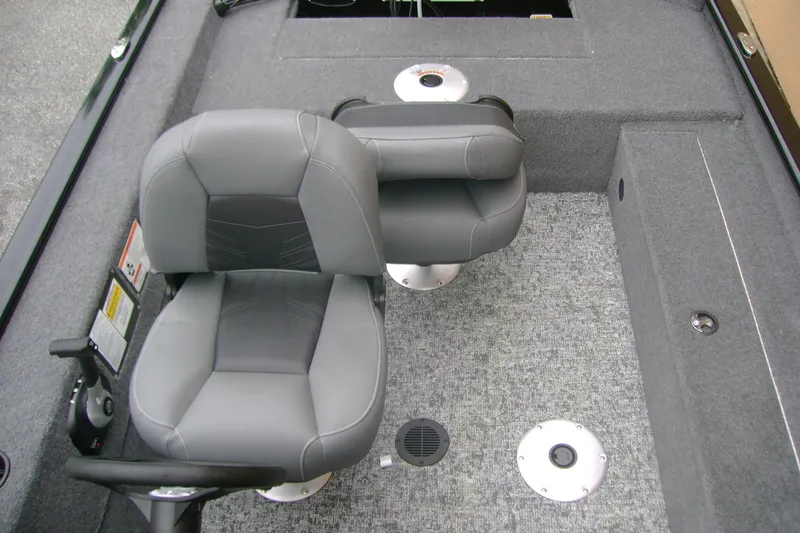 Slide: The Image of 2026 Tracker Super Guide V-16 SC boat interior with gray seating and carpeted flooring. - 9