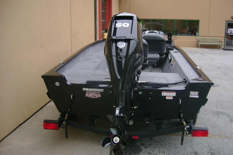 Slide: The Image of 2026 Tracker Super Guide V-16 SC boat with 50 HP outboard motor, parked outdoors. - 7