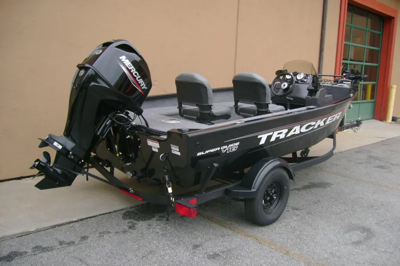 Slide: The Image of 2026 Tracker Super Guide V-16 SC boat with Mercury engine on trailer. - 4