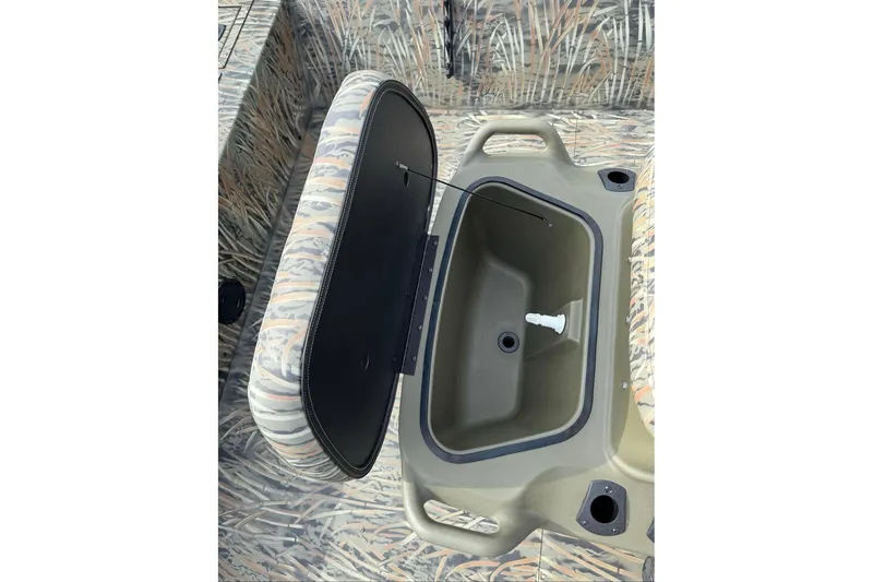 Slide: The Image of 2026 Tracker Grizzly 2072 CC boat with open storage compartment, camo design. - 12