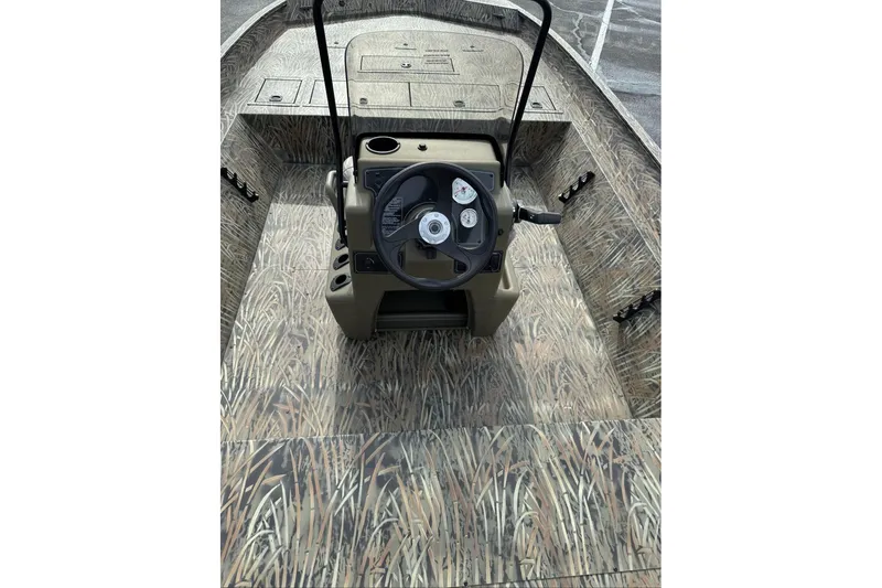 Slide: The Image of 2026 Tracker Grizzly 2072 CC boat interior with camouflage design and steering console. - 13