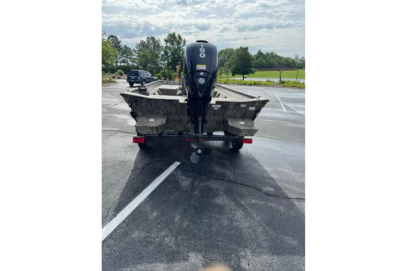 Slide: The Image of 2026 Tracker Grizzly 2072 CC boat on trailer in parking lot. - 10