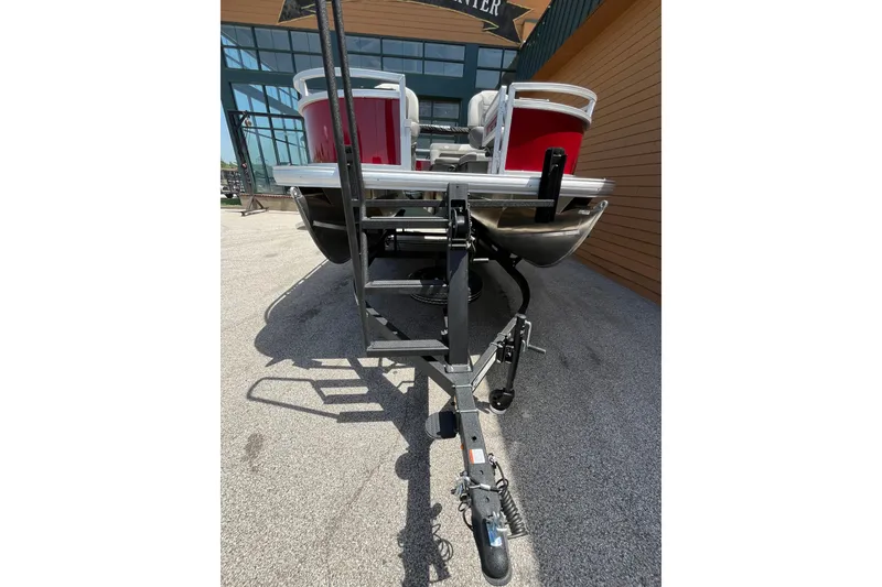 Slide: The Image of 2026 Sun Tracker Bass Buggy 16 XL Select pontoon boat on trailer, rear view. - 7