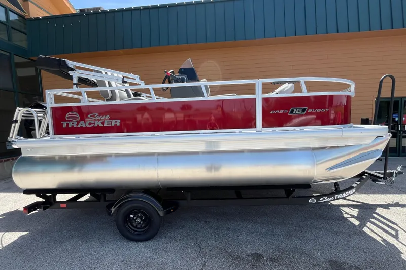 The Image of 2026 Sun Tracker Bass Buggy 16 XL Select pontoon boat on trailer, side view. - 0
