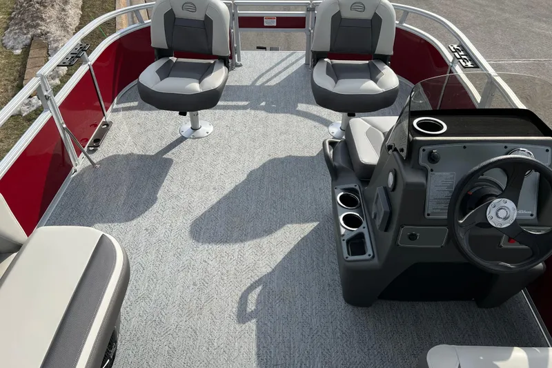 Slide: The Image of 2026 Sun Tracker Bass Buggy 16 XL Select pontoon boat interior with seating and steering console. - 4