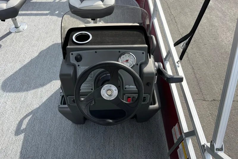 Slide: The Image of 2026 Sun Tracker Bass Buggy 16 XL Select steering console with gauge and cup holder. - 5