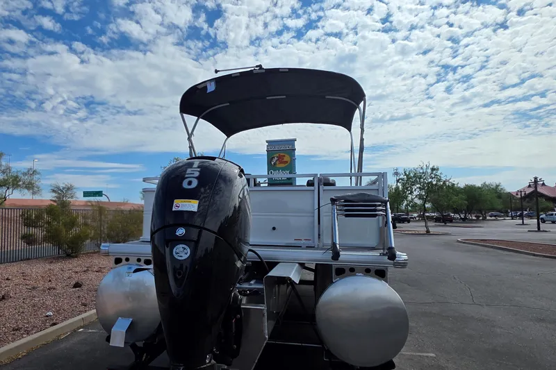 Slide: The Image of 2026 Sun Tracker Party Barge 22 RF XP3 pontoon boat with 150 HP engine in parking lot. - 3