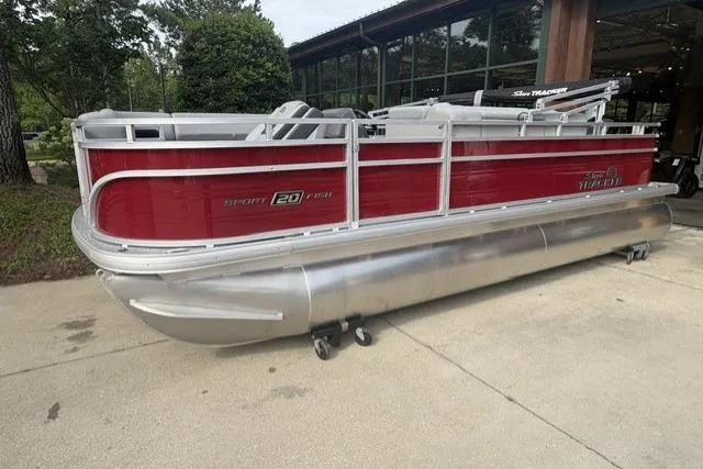 The Image of 2026 Sun Tracker SportFish 20 DLX pontoon boat with red and silver design, parked outdoors. - 0
