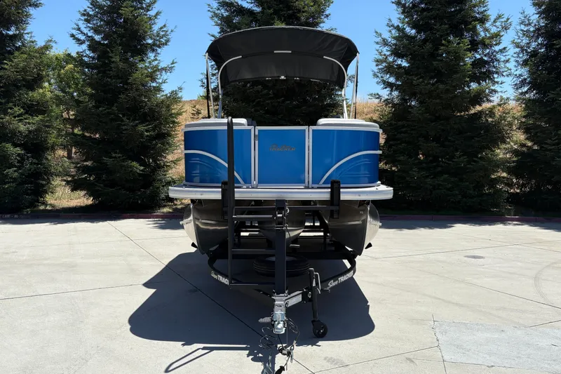 Slide: The Image of 2026 Sun Tracker Party Barge 22 XP3 pontoon boat on trailer, parked outdoors. - 11