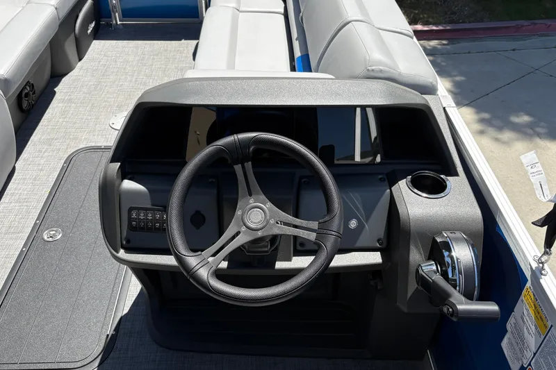 Slide: The Image of 2026 Sun Tracker Party Barge 22 XP3 steering console with modern controls and seating. - 19