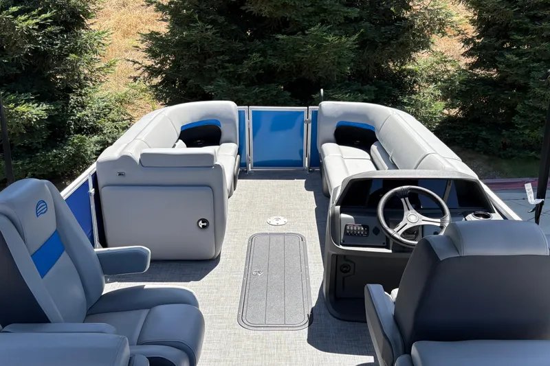 Slide: The Image of 2026 Sun Tracker Party Barge 22 XP3 interior with plush seating and steering console. - 16