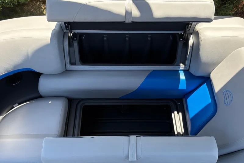 Slide: The Image of Sun Tracker Party Barge 22 XP3 2026, open storage compartment with blue and gray seating. - 25