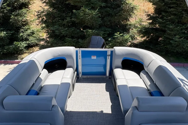Slide: The Image of 2026 Sun Tracker Party Barge 22 XP3 interior with plush seating and scenic backdrop. - 13
