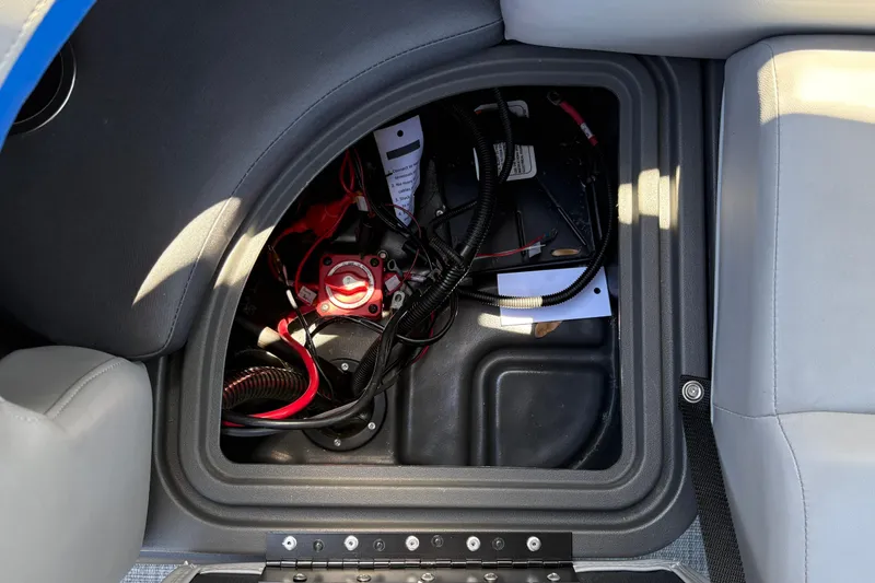 Slide: The Image of 2026 Sun Tracker Party Barge 22 XP3 battery compartment with wiring and components. - 23