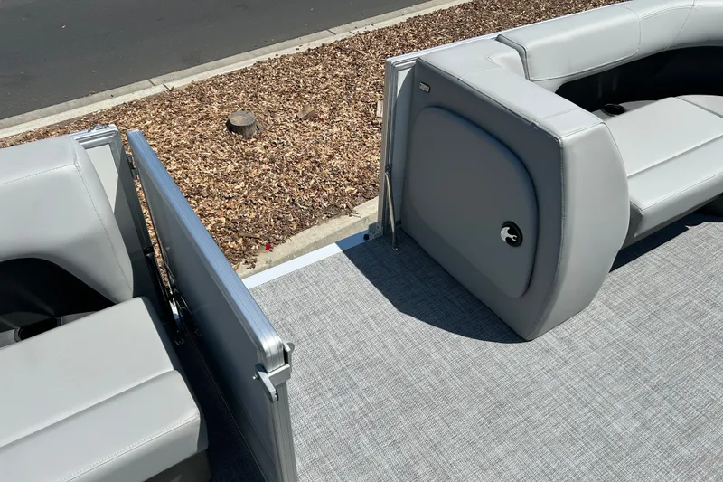 Slide: The Image of 2026 Sun Tracker Party Barge 18 DLX interior with gray seating and flooring. - 22