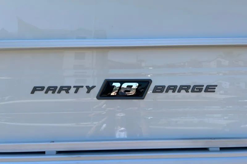 Slide: The Image of 2026 Sun Tracker Party Barge 18 DLX logo on boat exterior. - 24