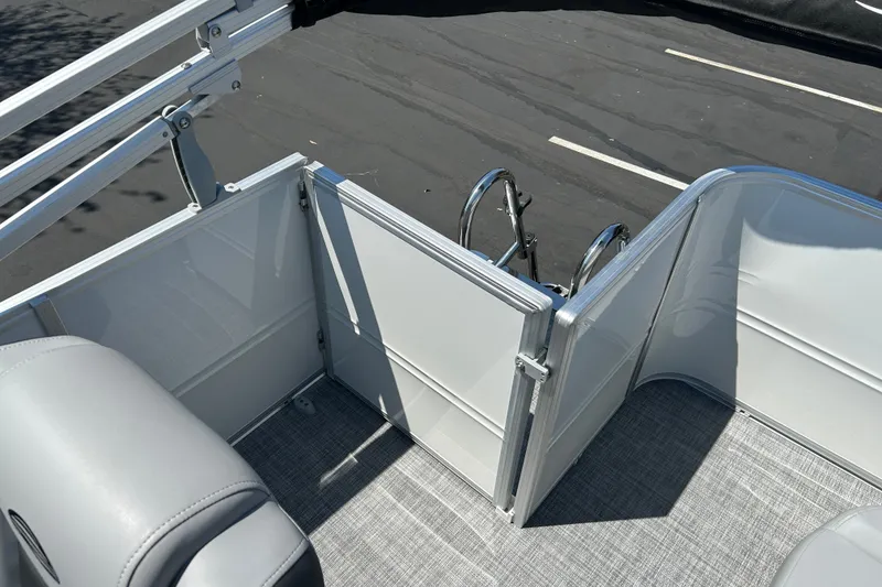 Slide: The Image of 2026 Sun Tracker Party Barge 18 DLX interior with seating and ladder. - 17