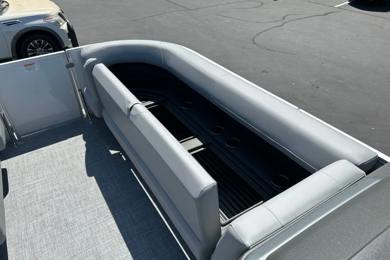 Slide: The Image of Interior view of 2026 Sun Tracker Party Barge 18 DLX with gray seating and cup holders. - 13