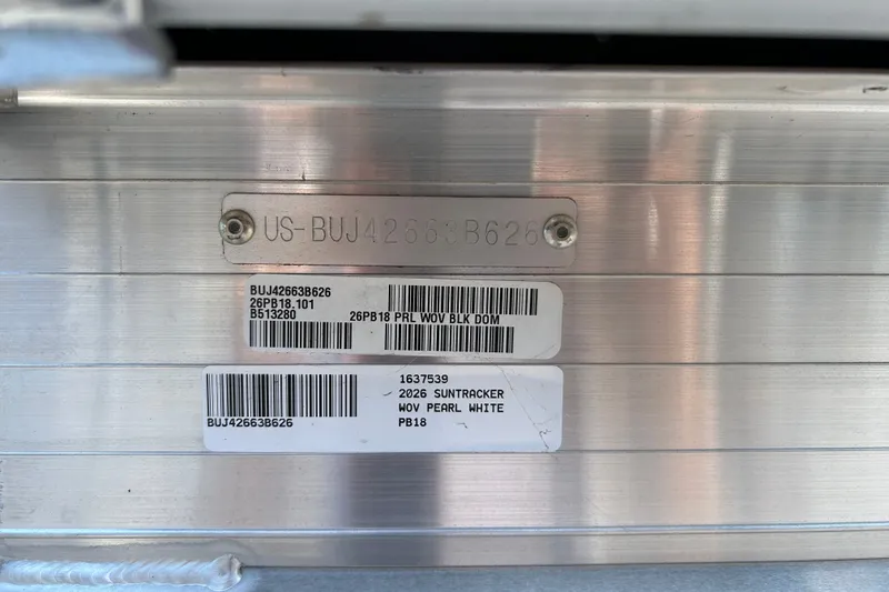 Slide: The Image of 2026 Sun Tracker Party Barge 18 DLX identification plate with serial numbers and barcodes. - 94