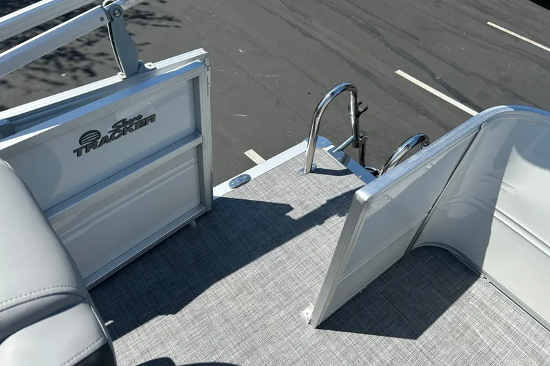 Slide: The Image of 2026 Sun Tracker Party Barge 18 DLX deck with open gate and ladder. - 18