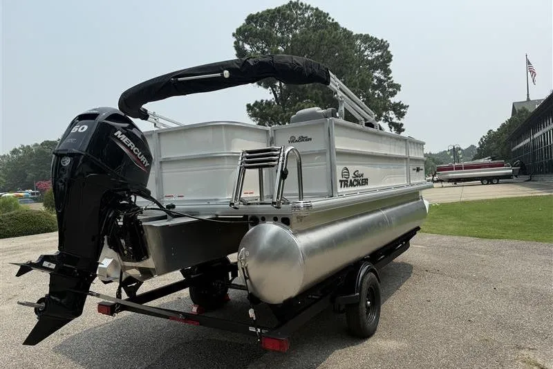 Slide: The Image of 2026 Sun Tracker Party Barge 18 DLX pontoon boat with Mercury engine on trailer. - 4